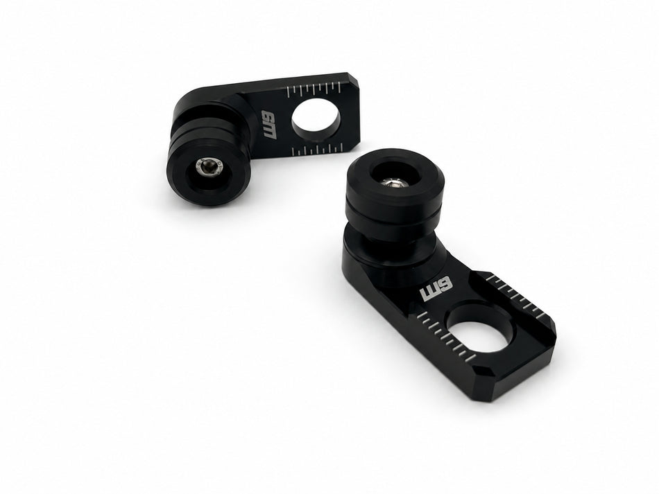 Warp 9 rear axle sliders: black anodized axle adjuster blocks with laser-etched chain marks and black UHMW spools