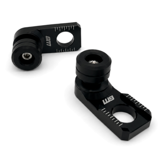 Warp 9 rear axle sliders: black anodized axle adjuster blocks with laser-etched chain marks and black UHMW spools