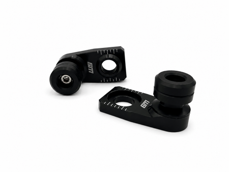 Warp 9 rear axle slider pair: black anodized axle blocks with etched chain alignment marks and black UHMW spools