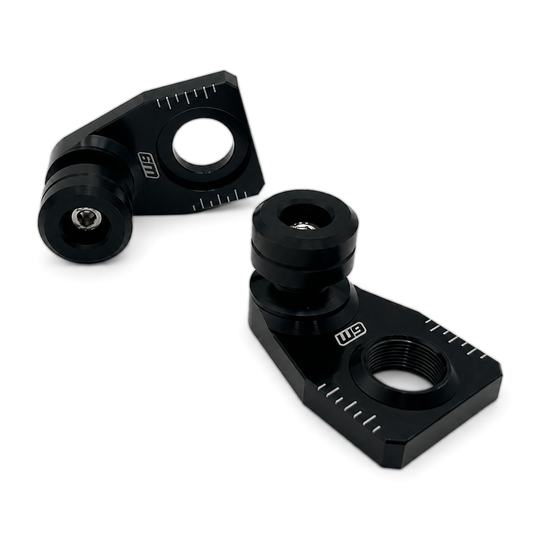Warp 9 rear axle sliders: angled black anodized adjuster blocks with chain alignment marks and black UHMW spools