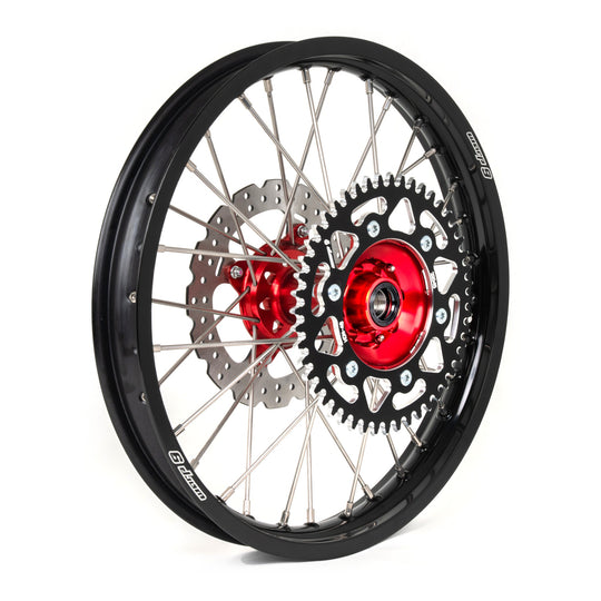 Warp 9 Honda rear wheel with a red hub, black rim, silver spokes, black sprocket and a drilled brake rotor