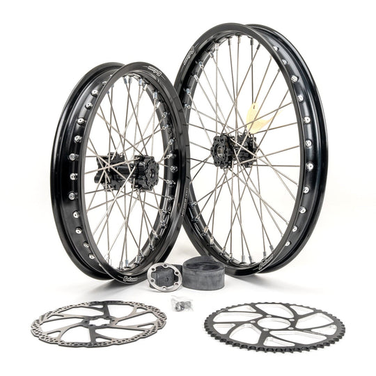 Warp 9 19/16 e-moto wheel set: black rims, black hubs and silver spokes, with two brake rotors, a rear sprocket, rim strip and hardware