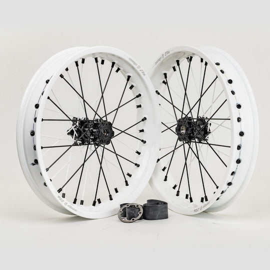 Pair of Warp 9 17-inch e-moto wheels with white rims, black hubs and black spokes and nipples, with wheel spacers