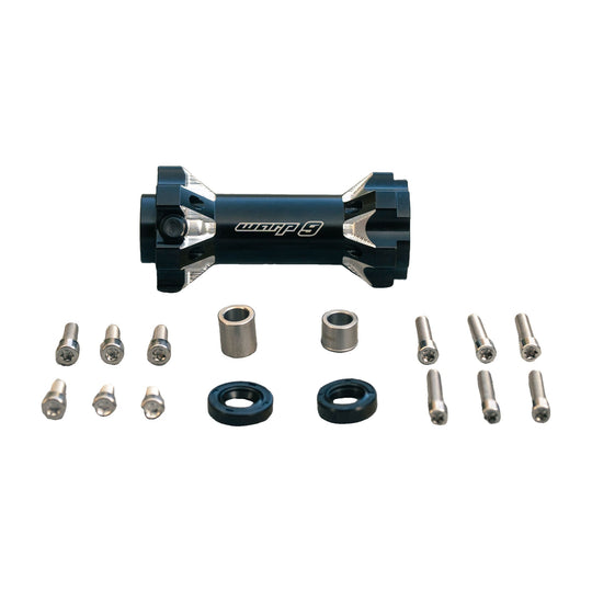 Warp 9 Light Bee jackshaft in black anodized aluminum with distance tube spacers, two seals and stainless Torx bolts laid out on concrete