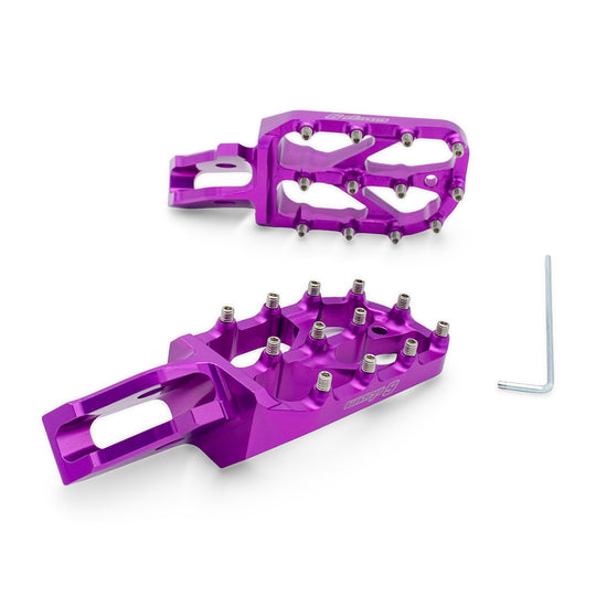 Pair of Warp 9 Ultra Bee Elite foot pegs in purple anodized aluminum with stainless teeth, with the included Allen key