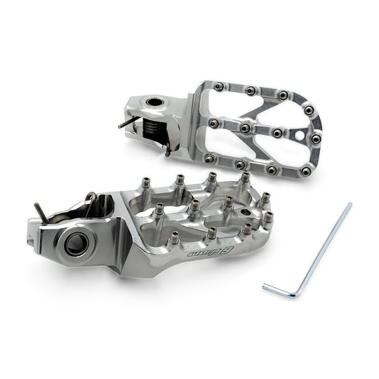 Pair of Warp 9 Stark Varg Elite foot pegs in silver anodized aluminum with stainless teeth and an Allen key