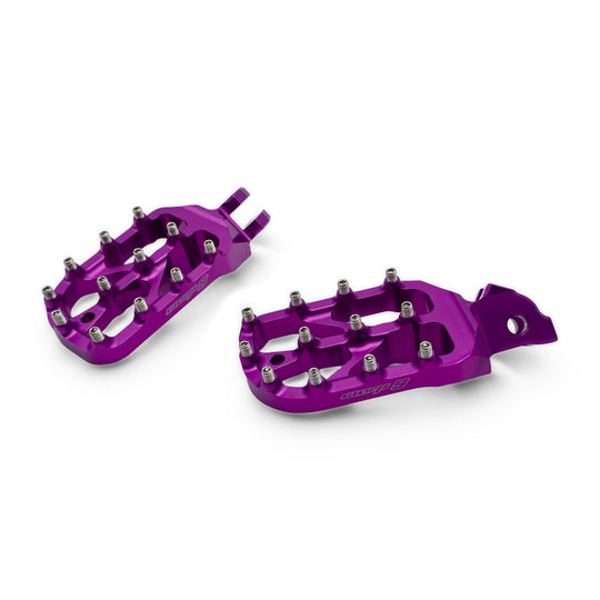 Pair of Warp 9 Elite foot pegs in purple anodized aluminum with stainless teeth