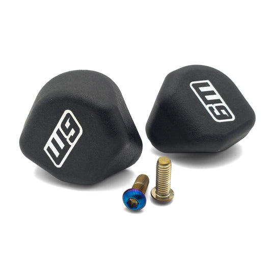 Pair of Warp 9 Elite foot peg sliders in black HDPE with W9 logos and mounting screws