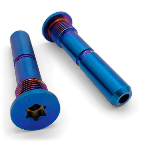 Warp 9 Stark Varg titanium peg pins in burnt blue with a tube of blue thread lock