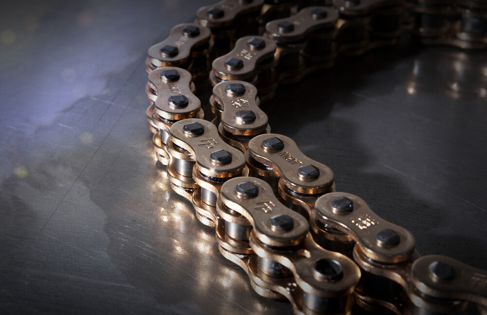 Close-up of Fire Power gold 520 chain side plates and pins