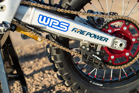 Fire Power gold 520 chain installed on a dirt bike with a red rear sprocket