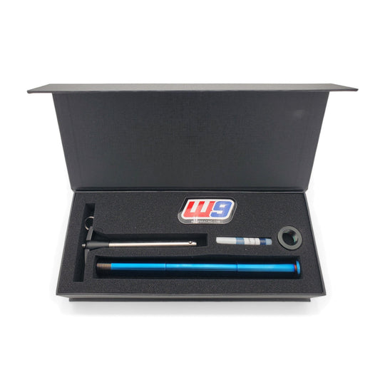 Warp 9 Ultra Bee titanium rear axle in burnt blue with its T-handle and nut in a Warp 9 presentation box