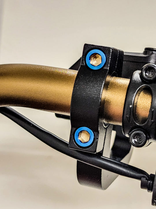 Warp 9 burnt blue titanium bolts on a Warp 9 handguard clamp