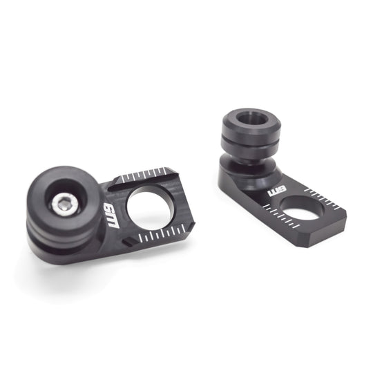 Warp 9 Honda rear axle sliders: black anodized axle blocks with chain alignment marks and black spools