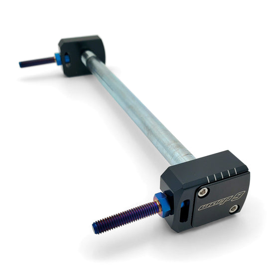 Warp 9 Talaria Sting lockdown axle blocks in black anodized aluminum with blue titanium adjusters on an axle